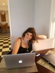Rachel Rofe sitting at her work desk in Los Angeles.